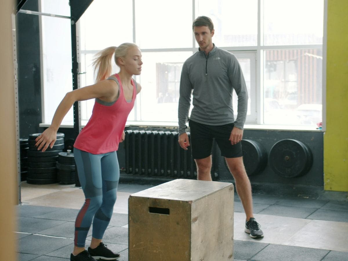 A coach watching an athlete train